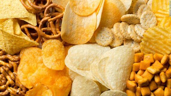 Chips, pretzels and crackers laid out.